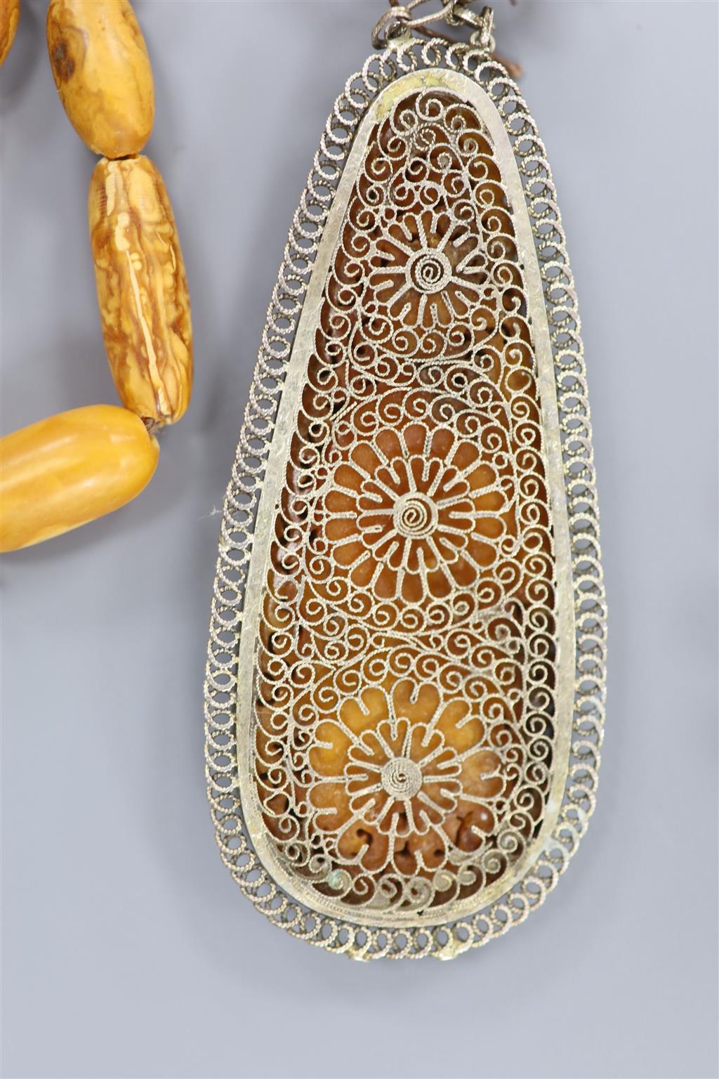 Two Chinese single strand amber necklaces.